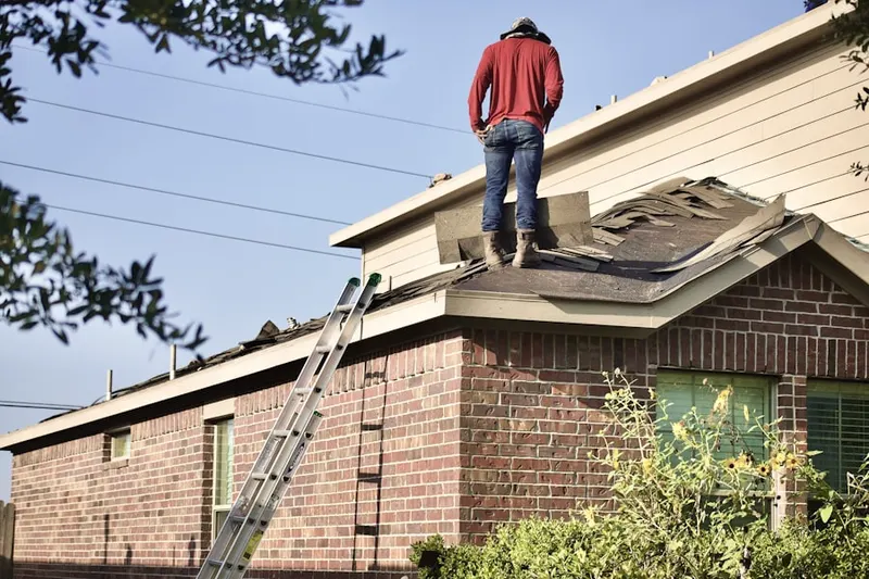 Professional roofer working on a residential roof in Blythedale